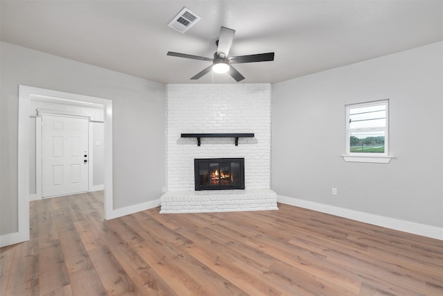 unfurnished living room featuring baseboards, ceiling fan, wood finished floors, and visible vents