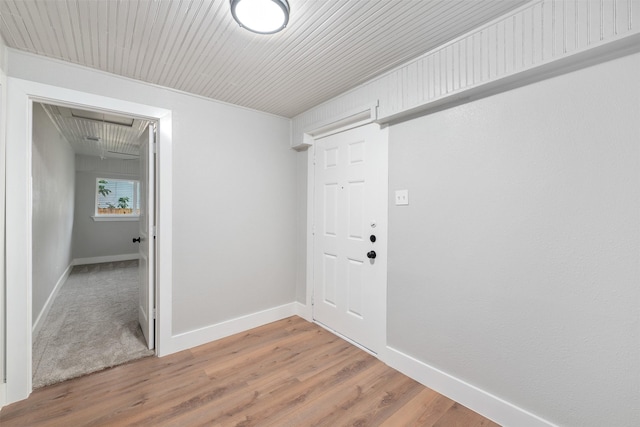 interior space featuring light wood-type flooring and baseboards