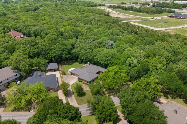 drone / aerial view featuring a wooded view