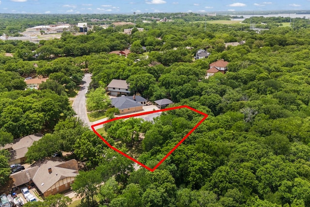 birds eye view of property with a wooded view