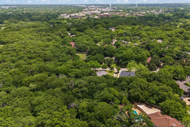drone / aerial view with a wooded view