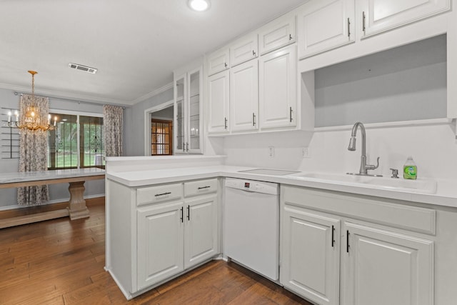kitchen featuring visible vents, crown molding, white dishwasher, white cabinetry, and a sink