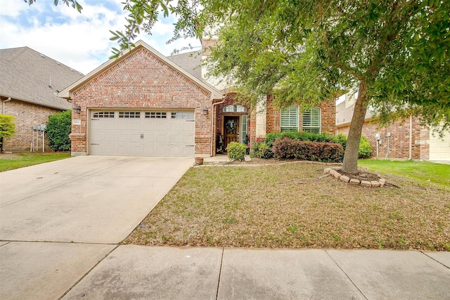 view of front of property with brick siding, an attached garage, a front yard, and concrete driveway