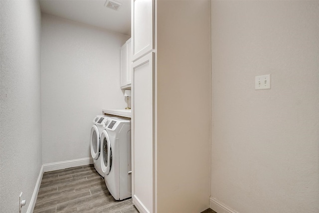 9820 Mullins Crossing Dr, Fort Worth, TX 76126 - washroom with cabinet space, washing machine and dryer, light wood-type flooring, and baseboards