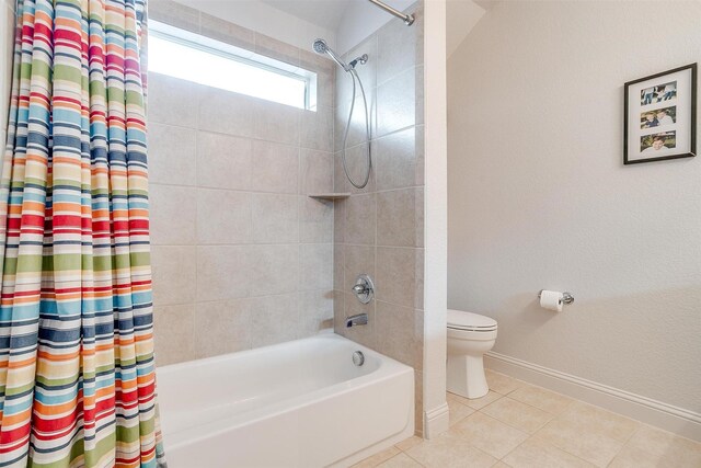full bath with toilet, baseboards, tile patterned flooring, and shower / bath combo with shower curtain