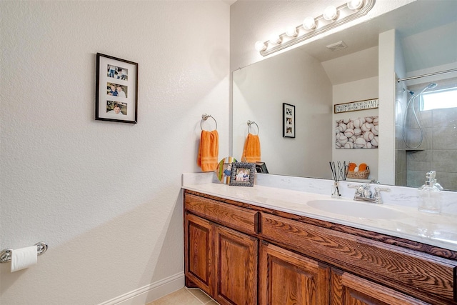 9820 Mullins Crossing Dr, Fort Worth, TX 76126 - bathroom with vanity, tile patterned flooring, a tile shower, and baseboards