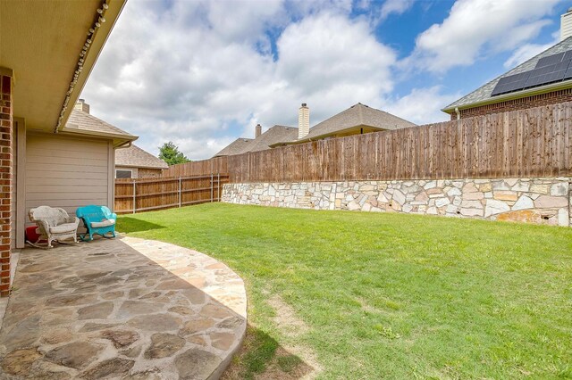 view of yard with a fenced backyard and a patio