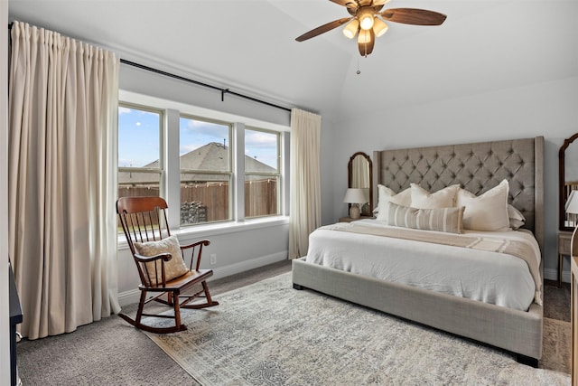 carpeted bedroom with baseboards and lofted ceiling