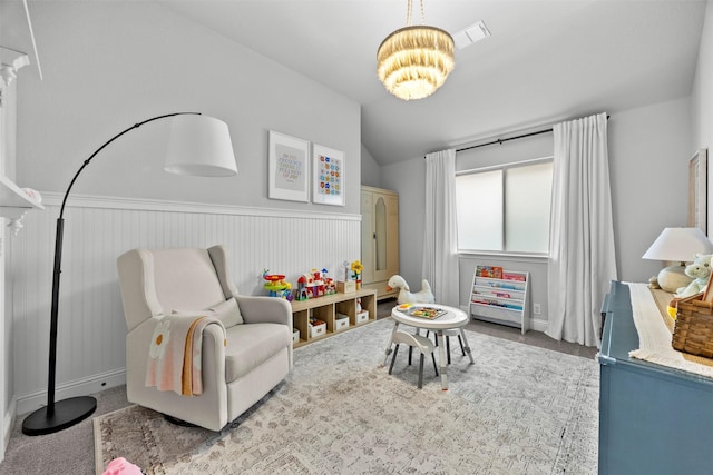 rec room featuring decorative columns, visible vents, wainscoting, lofted ceiling, and an inviting chandelier