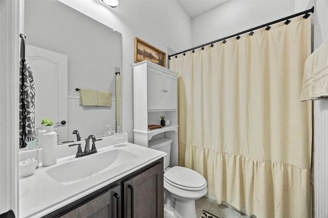 bathroom with vanity, tile patterned floors, and toilet