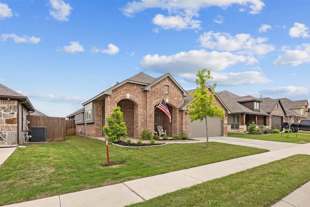 traditional home with a garage, central AC, fence, brick siding, and concrete driveway