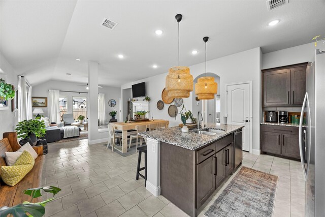 kitchen with a sink, stainless steel appliances, open floor plan, and visible vents