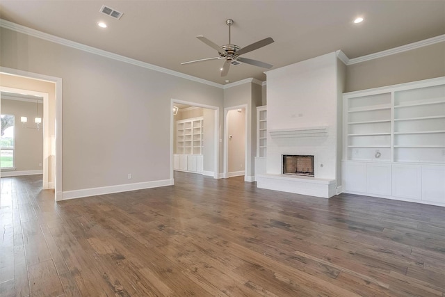 unfurnished living room featuring ceiling fan, visible vents, dark wood finished floors, a fireplace with raised hearth, and ornamental molding