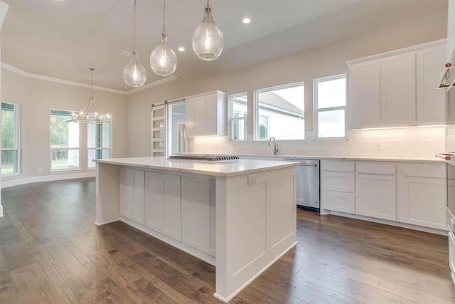 kitchen with crown molding, dishwasher, light countertops, a center island, and white cabinetry