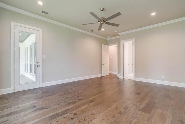 unfurnished room featuring visible vents, crown molding, wood finished floors, baseboards, and ceiling fan