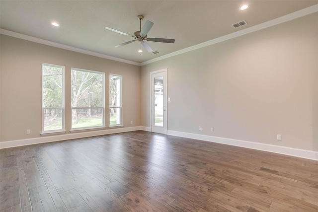 empty room with a ceiling fan, baseboards, visible vents, and wood finished floors