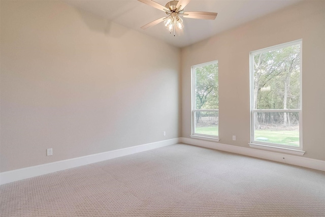 unfurnished room featuring baseboards, ceiling fan, and light carpet