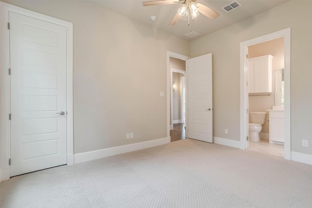 unfurnished bedroom with carpet flooring, baseboards, visible vents, and ensuite bath
