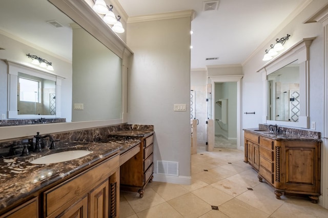 bathroom featuring visible vents, a sink, crown molding, and two vanities