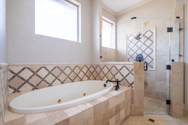 bathroom featuring crown molding, a whirlpool tub, tile patterned floors, and a stall shower