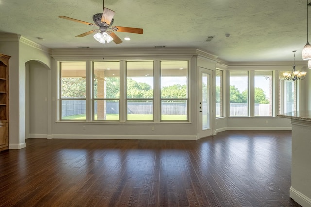 unfurnished living room with baseboards, plenty of natural light, ceiling fan with notable chandelier, and dark wood-type flooring