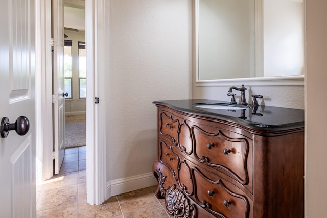 bathroom with baseboards and vanity