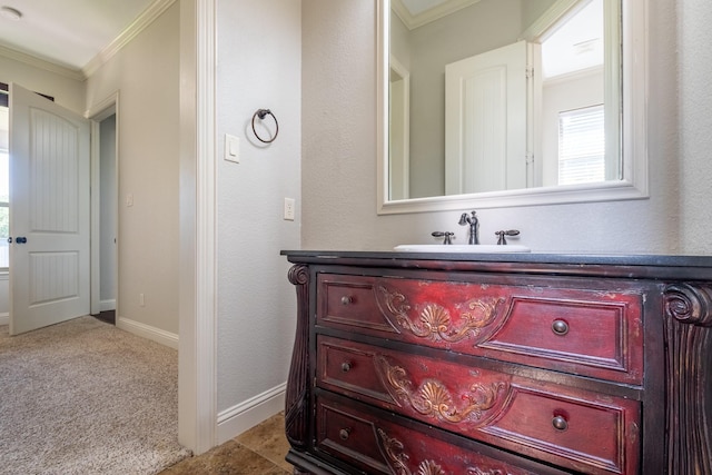 bathroom with crown molding, baseboards, and vanity