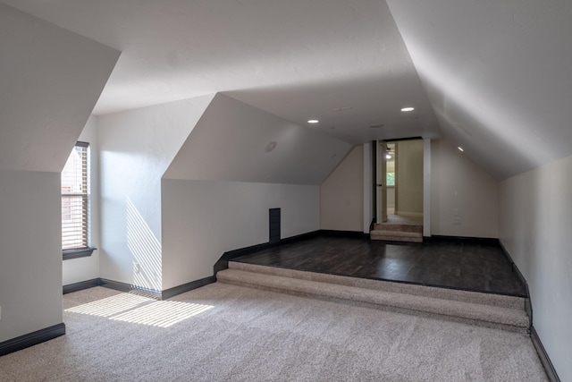 bonus room featuring carpet floors, baseboards, a healthy amount of sunlight, and lofted ceiling