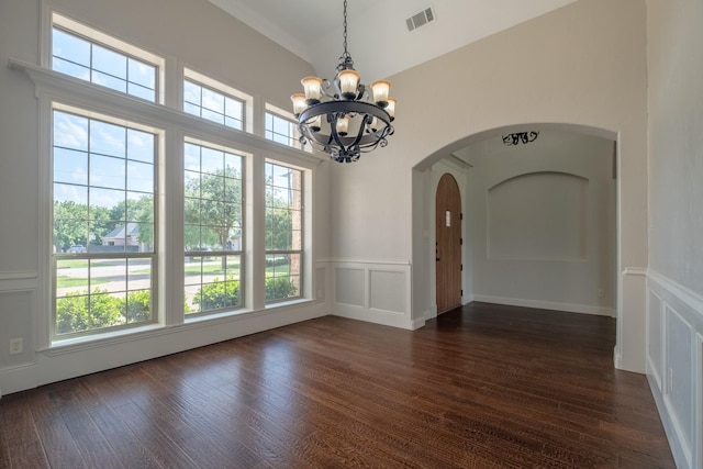 unfurnished dining area with visible vents, arched walkways, plenty of natural light, and a chandelier