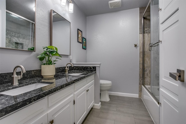 full bathroom featuring a sink, toilet, double vanity, and visible vents