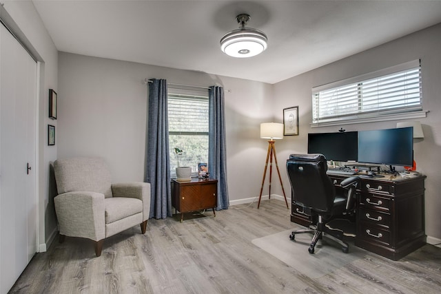 home office with baseboards and light wood finished floors