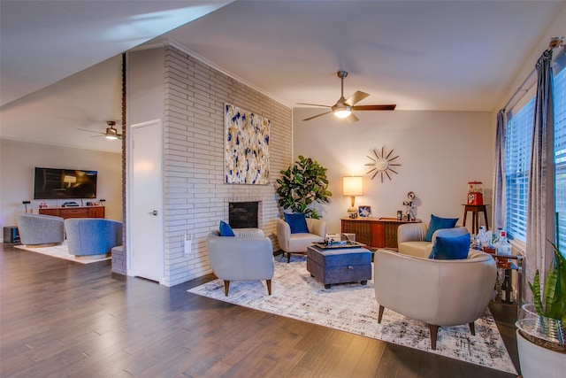 living room with a fireplace, a ceiling fan, and wood finished floors