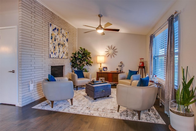 living room featuring a fireplace, a ceiling fan, wood finished floors, and lofted ceiling