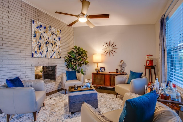 interior space featuring ceiling fan, a fireplace, brick wall, and wood finished floors