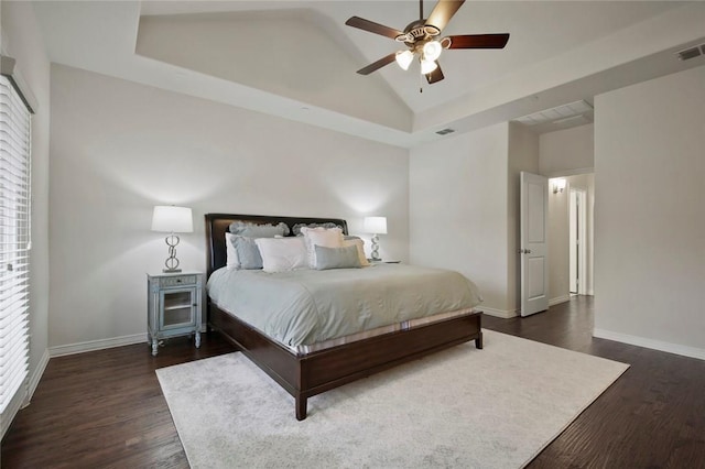 bedroom with baseboards, a ceiling fan, dark wood-style flooring, and lofted ceiling