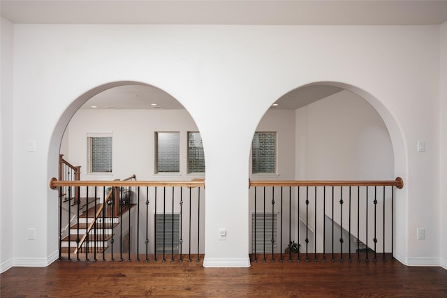hallway featuring baseboards and wood finished floors