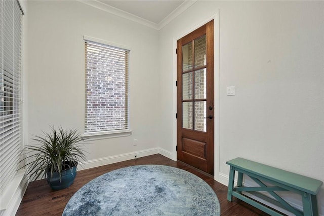 foyer featuring plenty of natural light, baseboards, crown molding, and wood finished floors