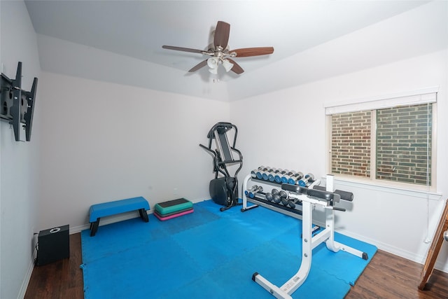 workout area featuring baseboards, a ceiling fan, and wood finished floors