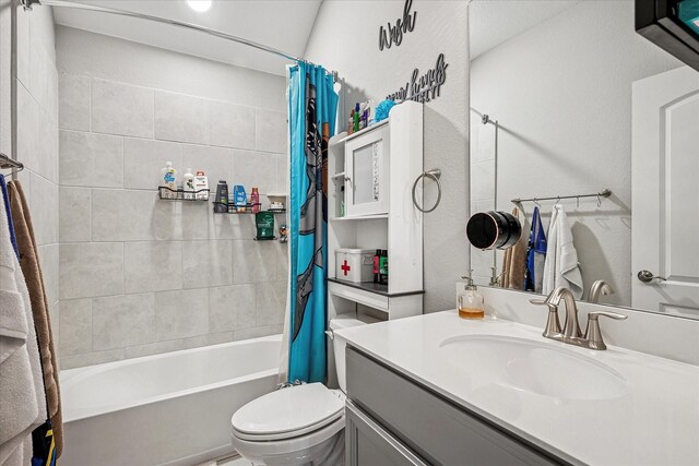 bathroom featuring vanity, toilet, and shower / bath combo with shower curtain