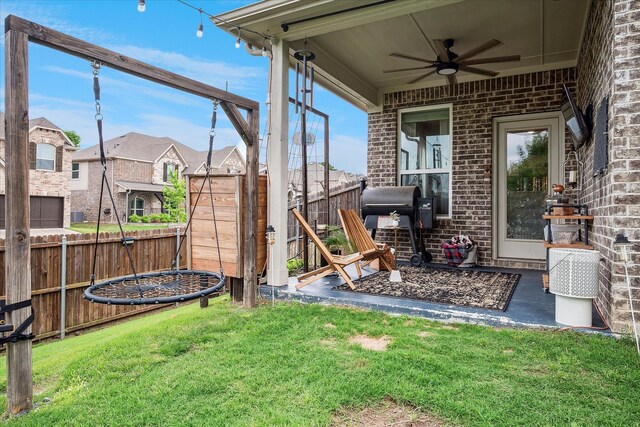 view of yard with ceiling fan, a residential view, and a fenced backyard