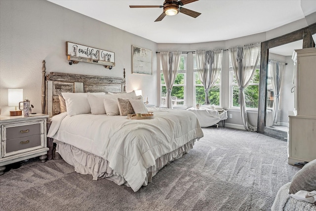carpeted bedroom with baseboards and a ceiling fan