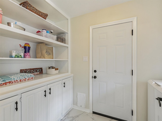 interior space with washer / clothes dryer and marble finish floor