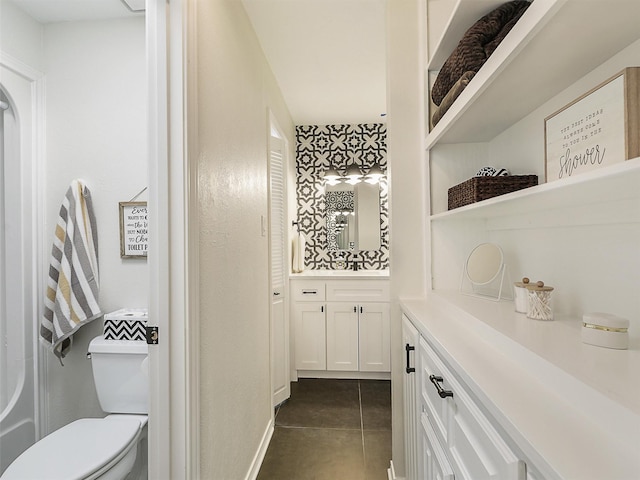 bathroom featuring vanity, tile patterned floors, and toilet