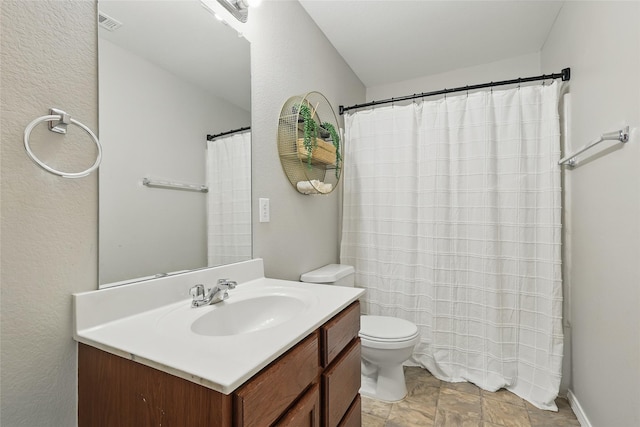 1612 Cambridge Dr, Providence Village, TX 76227 - full bathroom with stone finish flooring, visible vents, vanity, toilet, and a shower with shower curtain