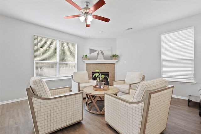 1612 Cambridge Dr, Providence Village, TX 76227 - living area with ceiling fan, visible vents, a tiled fireplace, and baseboards