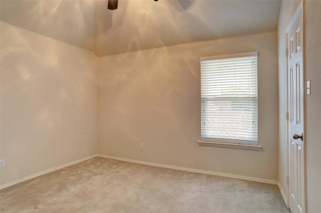 unfurnished room featuring baseboards, ceiling fan, and light carpet