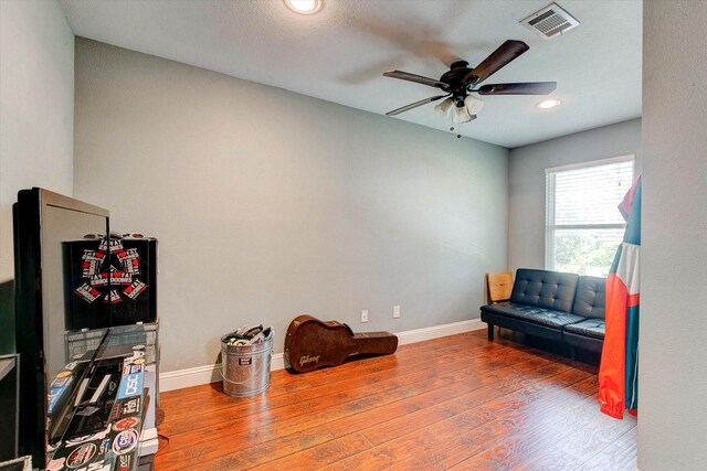 sitting room featuring baseboards, ceiling fan, wood finished floors, and visible vents