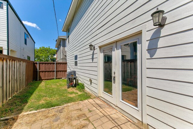 exterior space with a lawn, a patio area, and fence