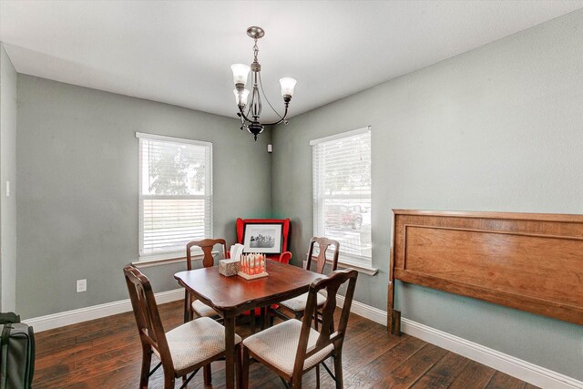 dining room featuring baseboards, dark wood-style flooring, and a notable chandelier