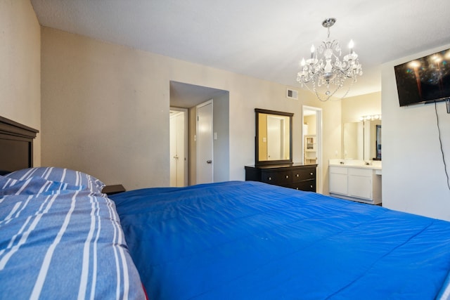 bedroom with ensuite bathroom, a chandelier, and visible vents